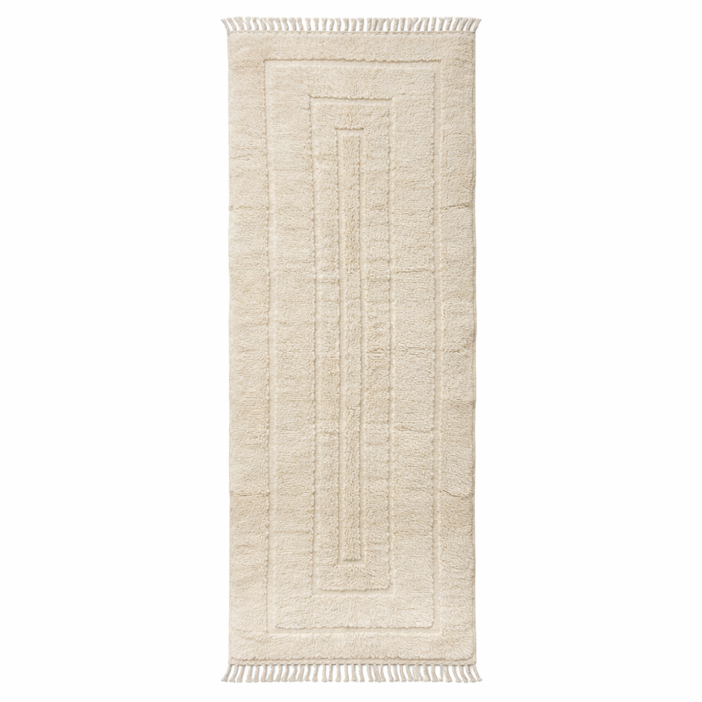 Handmade Moroccan wool runner rug in cream with raised carved geometric design and fringed ends