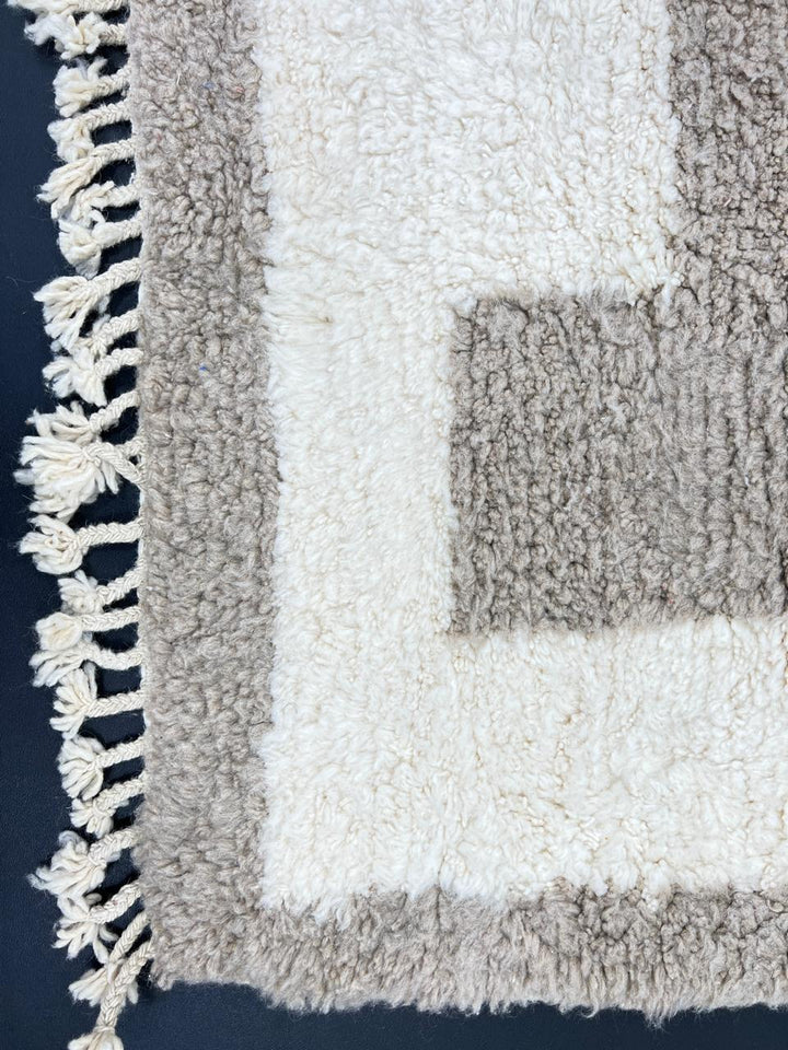 Handwoven Moroccan wool runner rug in white with sand border, minimalist modern design