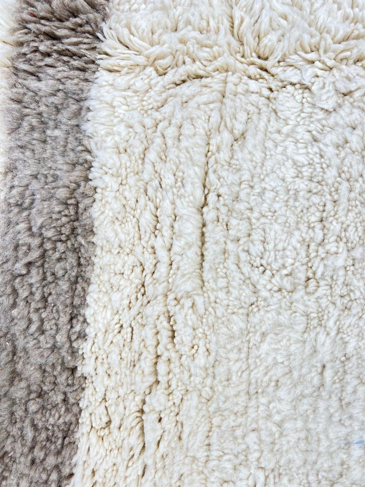 Handwoven Moroccan wool runner rug in white with sand border, minimalist modern design