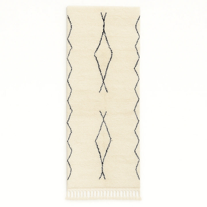 Handwoven white and black Moroccan wool runner rug with minimalist geometric lines, inspired by Beni Ourain design