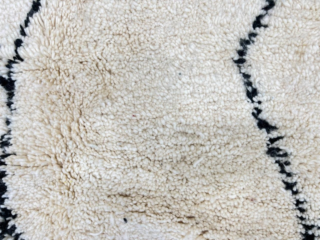 Handwoven white and black Moroccan wool runner rug with minimalist geometric lines, inspired by Beni Ourain design