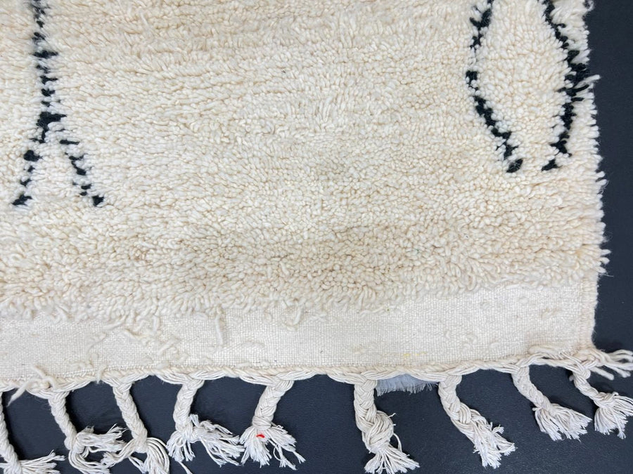 Handwoven white and black Moroccan wool runner rug with minimalist geometric lines, inspired by Beni Ourain design