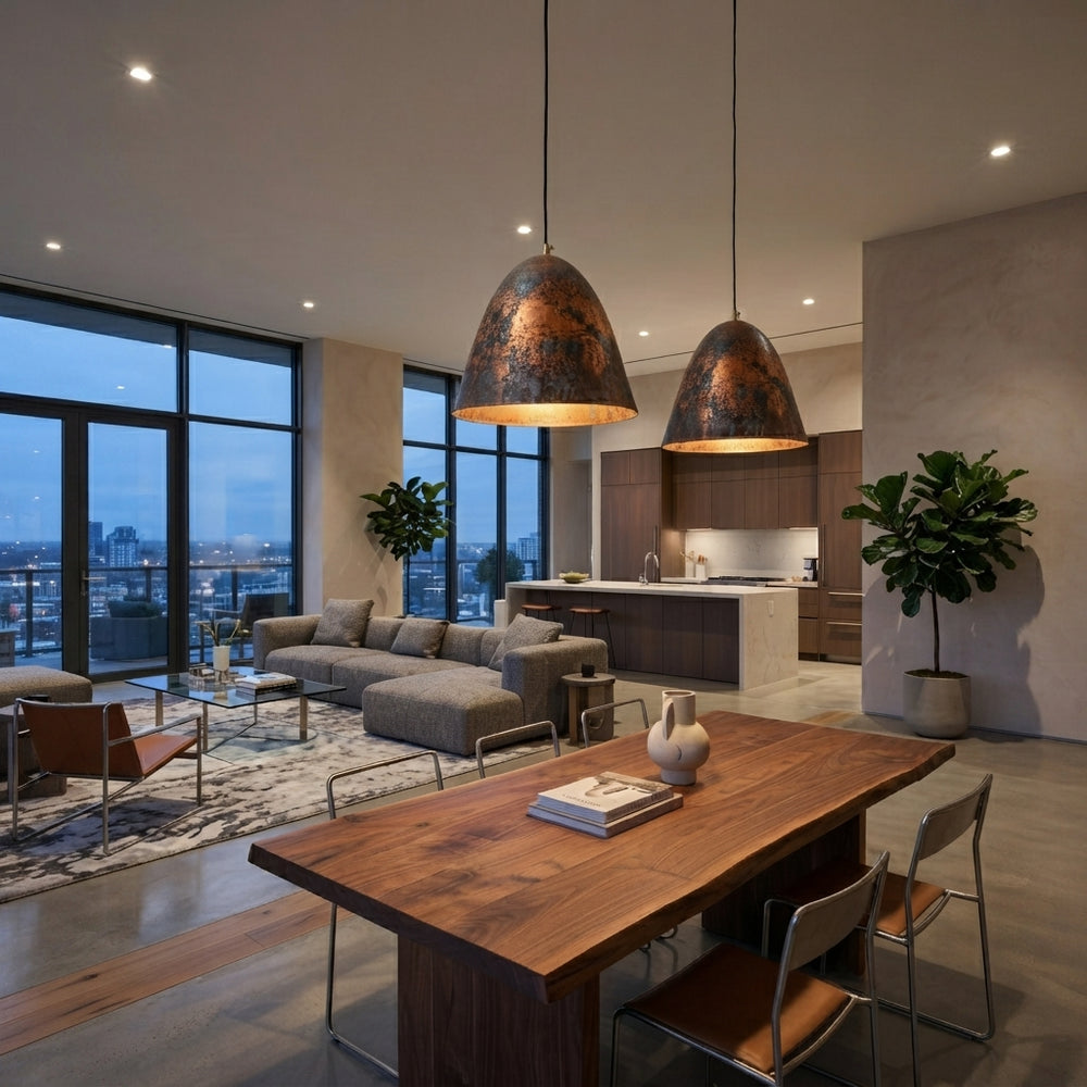 Handmade aged copper dome pendant light with a dark distressed patina in a modern industrial interior.