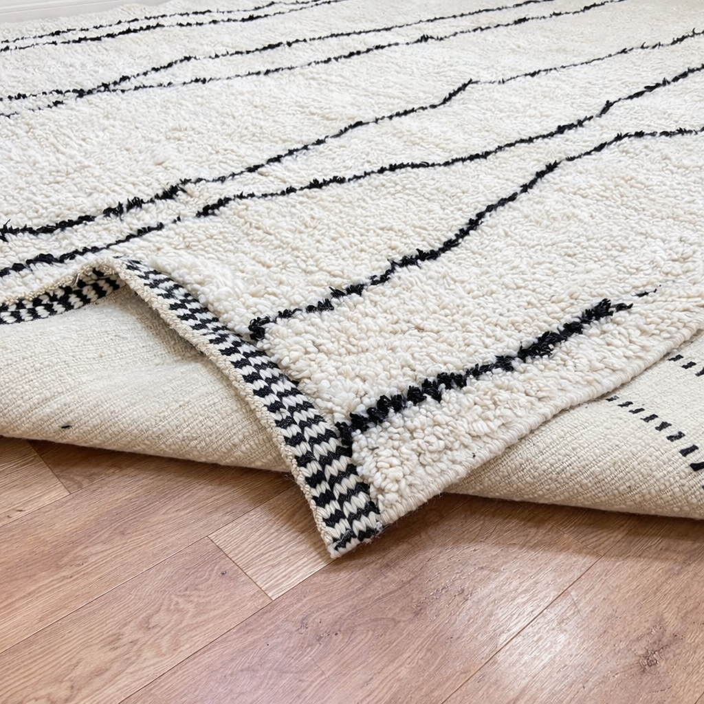 Handmade Moroccan wool runner rug in white with black abstract lines, minimalist design for hallway or entryway.