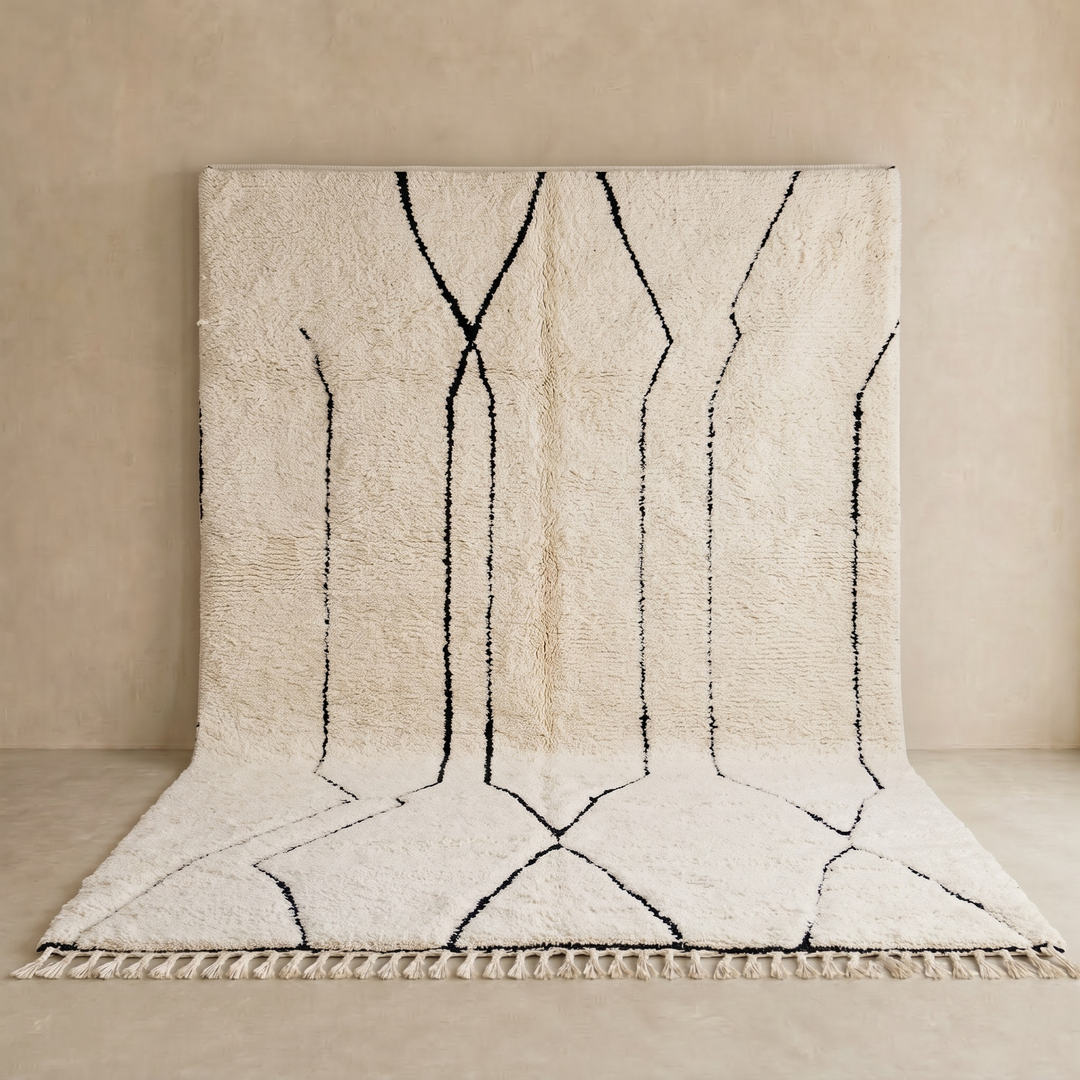 Handmade Moroccan Beni Ourain wool rug in ivory with black abstract geometric lines and tassels