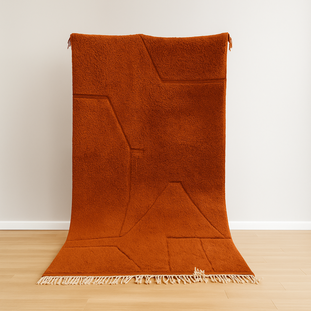 Brown woven blanket on a wooden floor with a white wall background