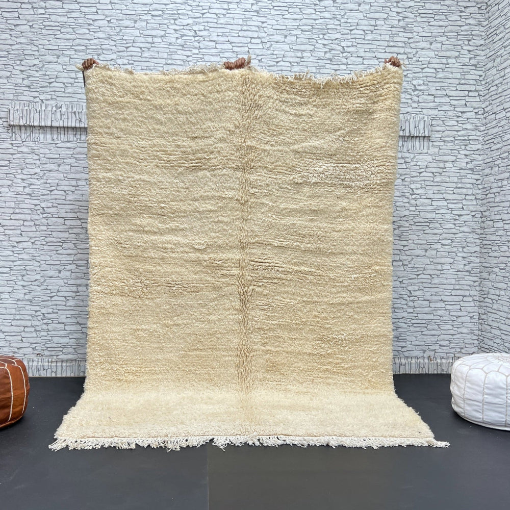 Cream Beni Ourain rug handmade in Morocco from natural wool, soft plush texture with minimalist Berber design.