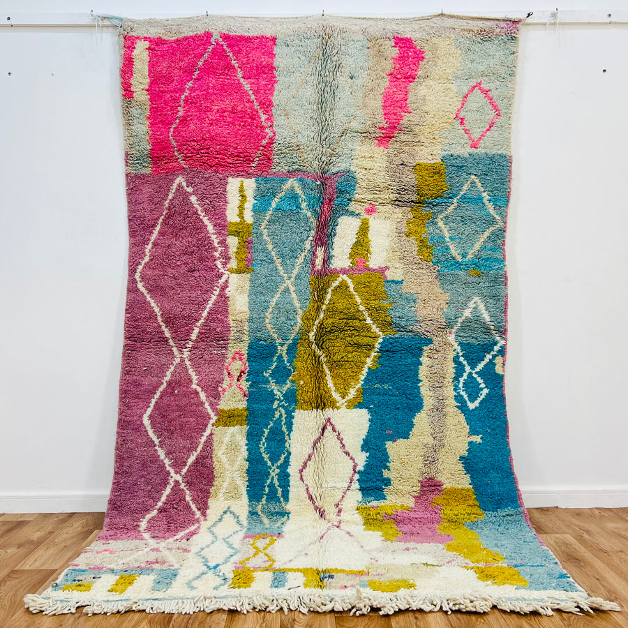 Vintage Moroccan rug, 8.5x5.3 ft, pink & blue abstract, Berber-inspired design with diamond motifs, natural wool, vibrant colors.