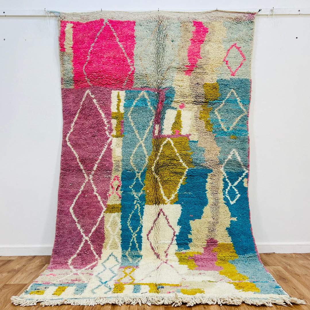 Vintage Moroccan Berber rug with pink and blue abstract diamond patterns, handwoven, 8.5x5.3 ft, 100% natural wool.