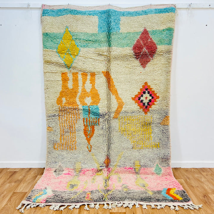 Vintage Moroccan wool rug with colorful tribal symbols, handmade by Berber women. Perfect for boho decor. 8.5x5.1 ft.