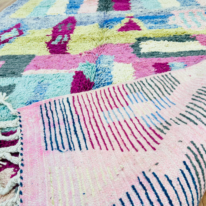 Colorful Moroccan Berber rug with geometric patterns in pink, blue, yellow, and green stripes; handmade wool rug 8x5 ft.
