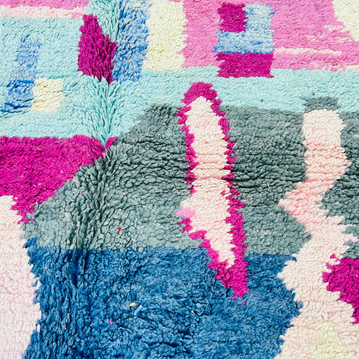 Vibrant vintage Moroccan Berber rug with bold geometric patterns in pink, blue, and green. 8x5 ft area rug, handwoven with 100% wool.