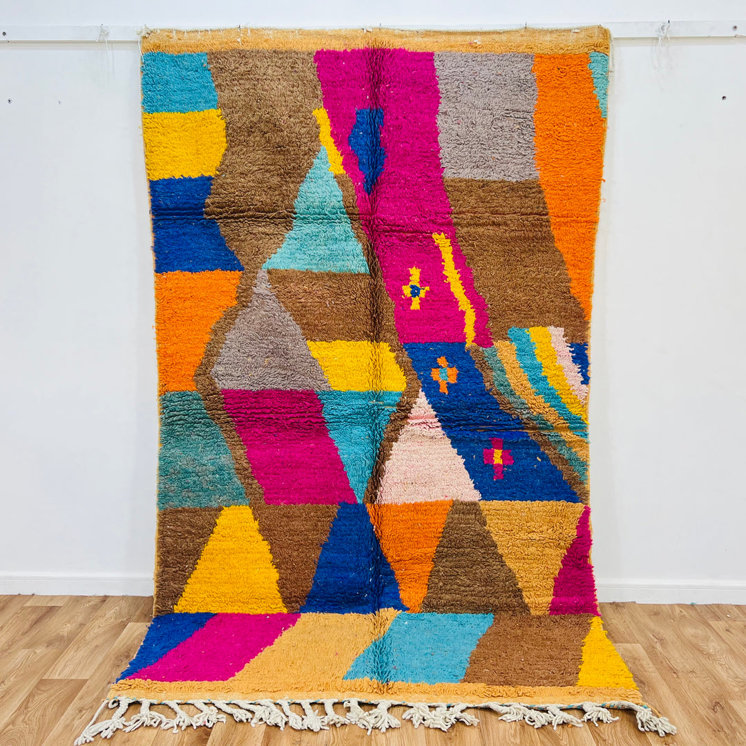 Colorful vintage Moroccan Berber rug with geometric patterns in pink, turquoise, brown, and cobalt. Handmade wool rug 8.2x5 ft.