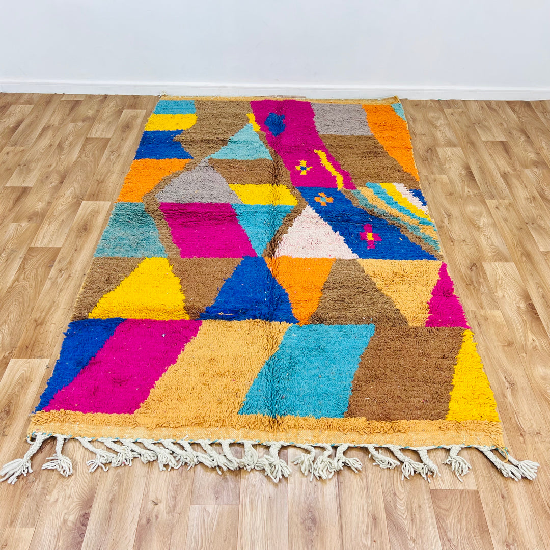 Vintage Moroccan rug with geometric design in brown, pink, turquoise, yellow, and blue, handcrafted by Berber artisans.