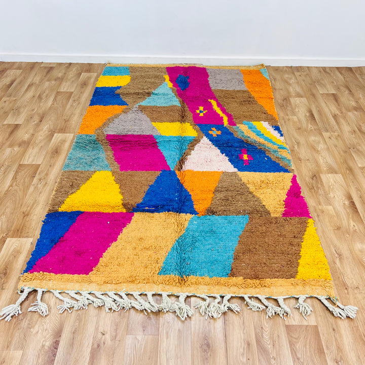 Vintage Moroccan rug with geometric design in brown, pink, turquoise, yellow, and blue, handcrafted by Berber artisans.