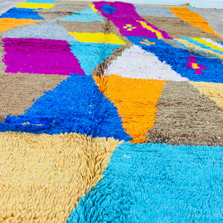 Vintage Moroccan rug with vibrant geometric patchwork in brown, pink, turquoise, yellow, cobalt blue; handmade Berber wool carpet.