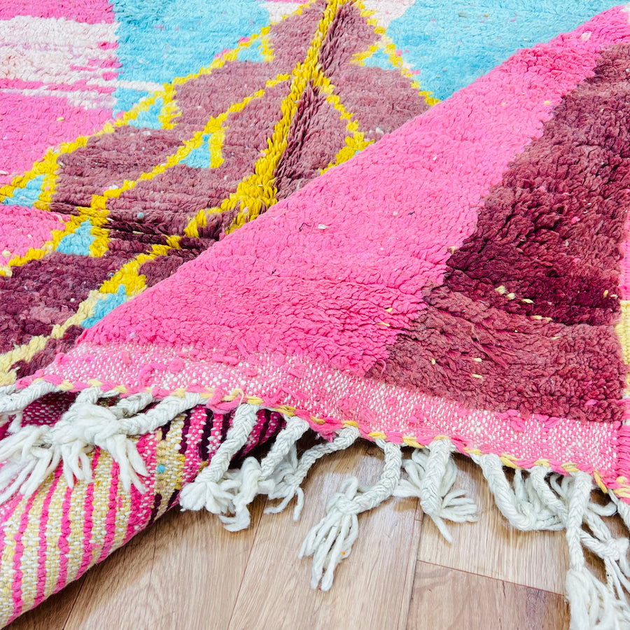 Vintage Moroccan wool rug in pink and aqua with Berber tribal designs, showcasing fuchsia, turquoise, yellow, and brown colors.