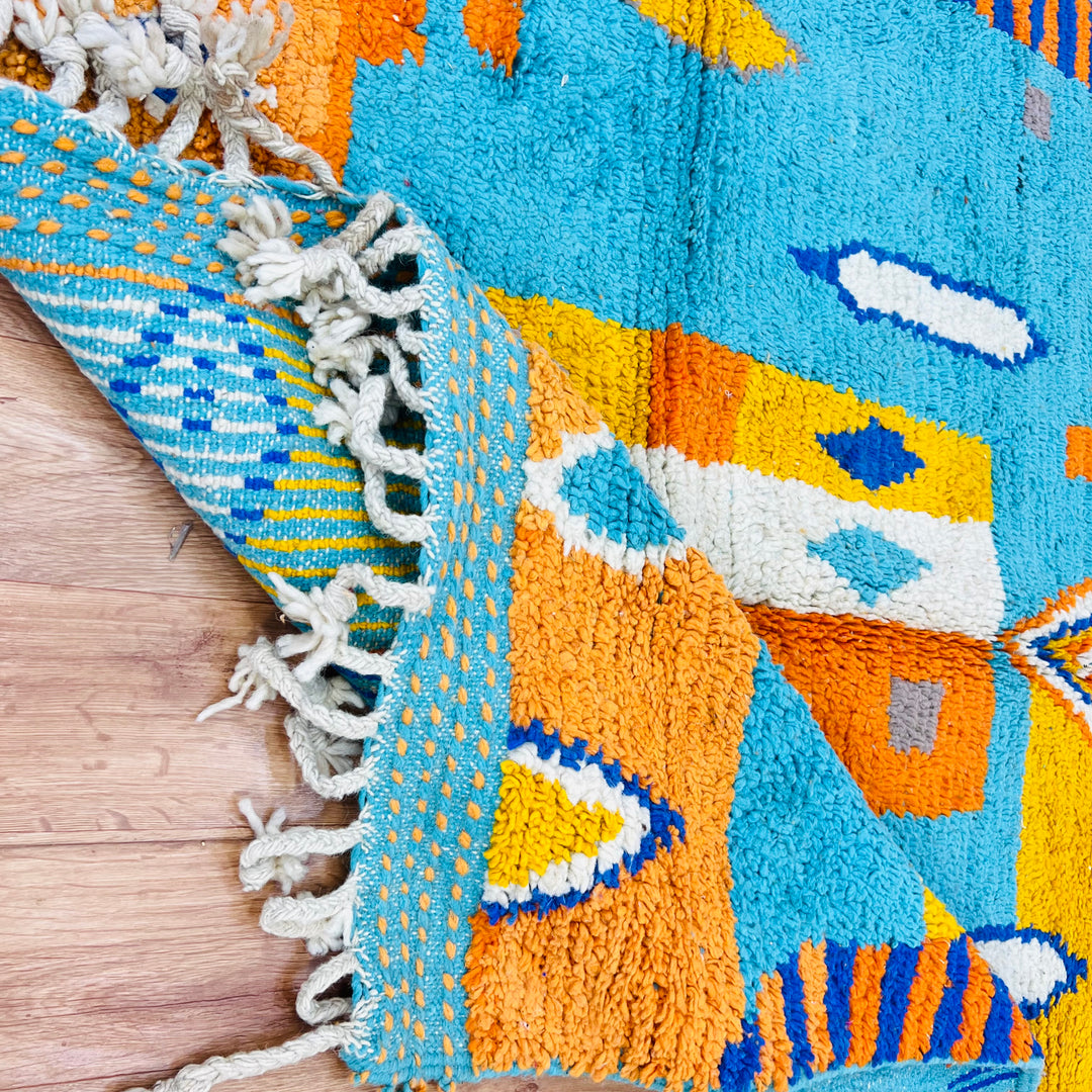 Blue Orange Moroccan Berber rug with geometric diamond patterns, crafted from 100% wool, perfect for boho or modern interiors.
