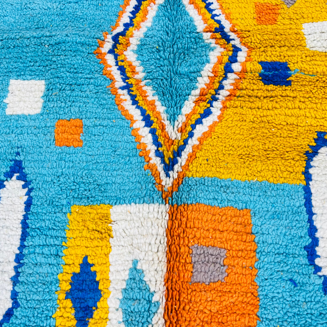 Blue orange Moroccan Berber rug with geometric diamond pattern, handcrafted from 100% wool by Berber artisans.