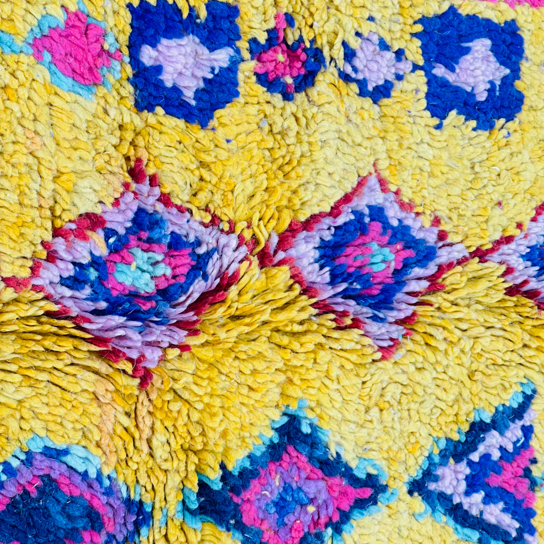 Yellow Moroccan Berber rug with colorful geometric patterns, showcasing traditional tribal designs and vibrant artistry.
