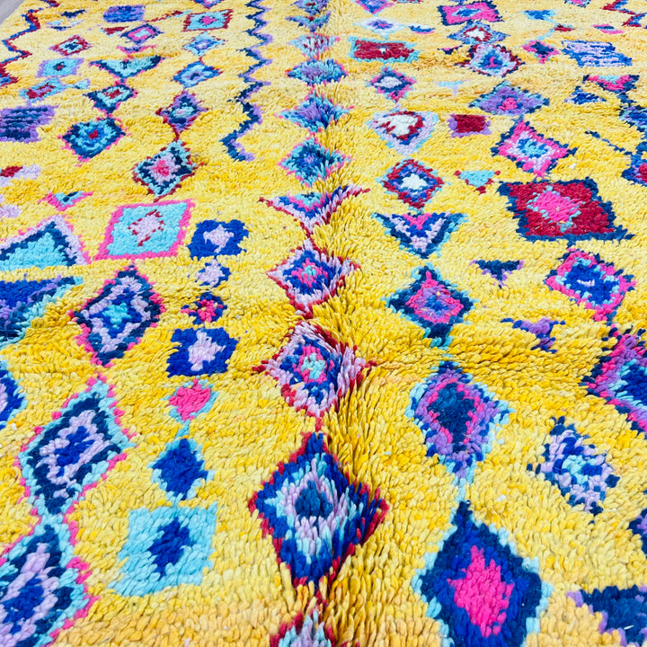 Vibrant yellow Moroccan Berber rug with colorful geometric patterns, perfect for boho decor. Size: 254x157 cm. Traditional Moroccan artistry.