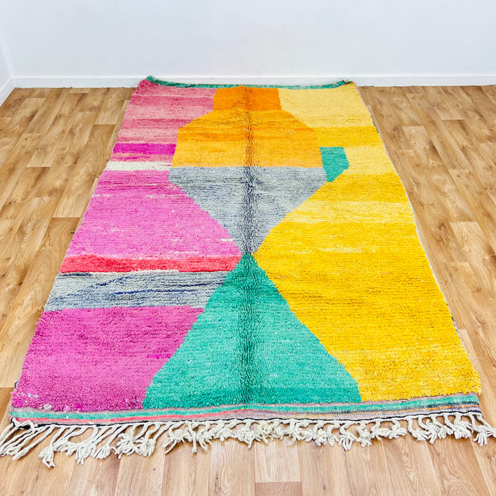 Colorful vintage Moroccan abstract rug with bold pink, yellow, orange, and green patterns, handwoven by Berber artisans.