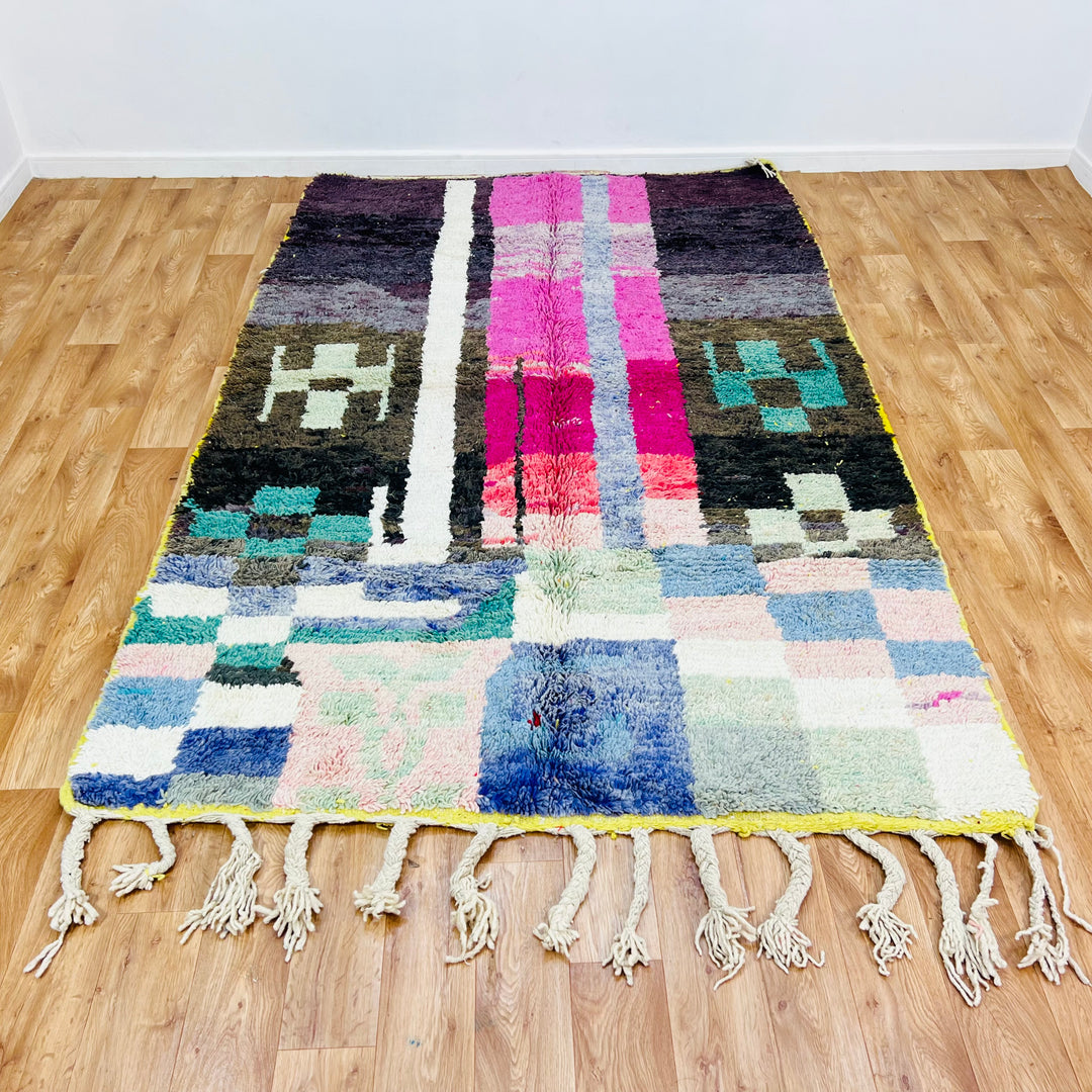 Colorful abstract vintage Moroccan rug with geometric designs in neon and earthy tones, perfect for eclectic boho interiors.