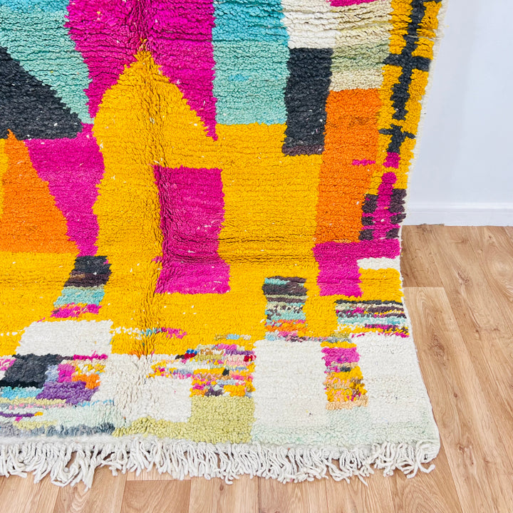 Vintage Moroccan rug with vibrant magenta, mustard, and teal colors, handcrafted by Berber women, 8.56 x 5.02 ft in size.