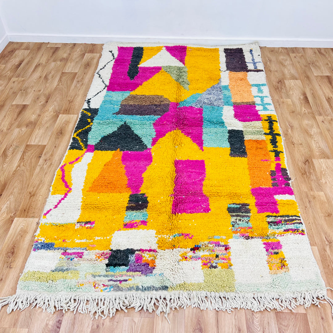 Colorful vintage Moroccan rug with abstract design, featuring bold magenta, mustard, and teal. Handwoven Berber wool rug.