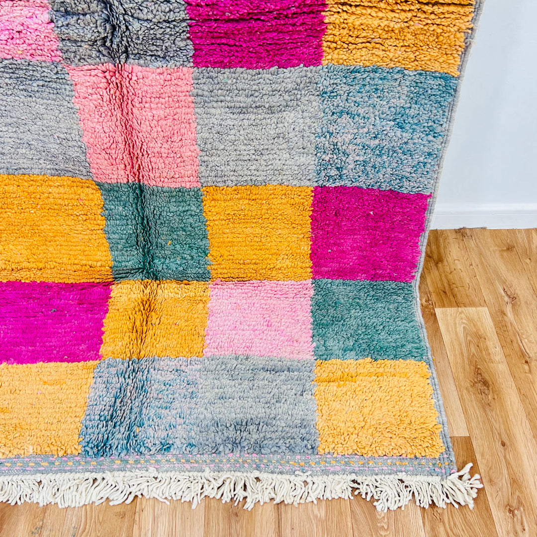 Vintage Moroccan area rug with color block design in pink, mustard, sage, grey, and orange tones. Handwoven Berber craftsmanship.