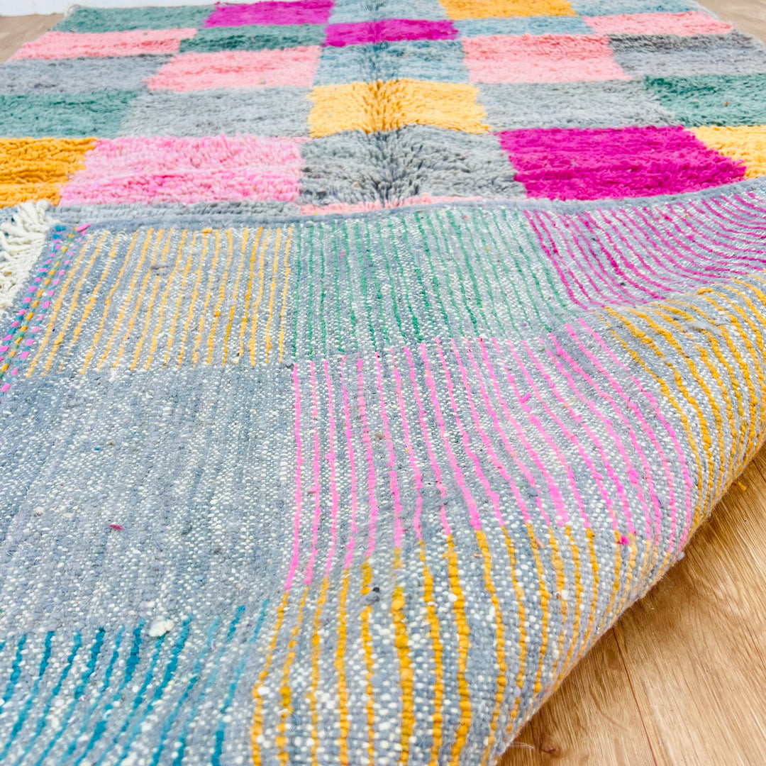 Vintage Moroccan rug with vivid pink, mustard, and green checkerboard pattern. Handwoven by Berber artisans. Perfect for bohemian decor.