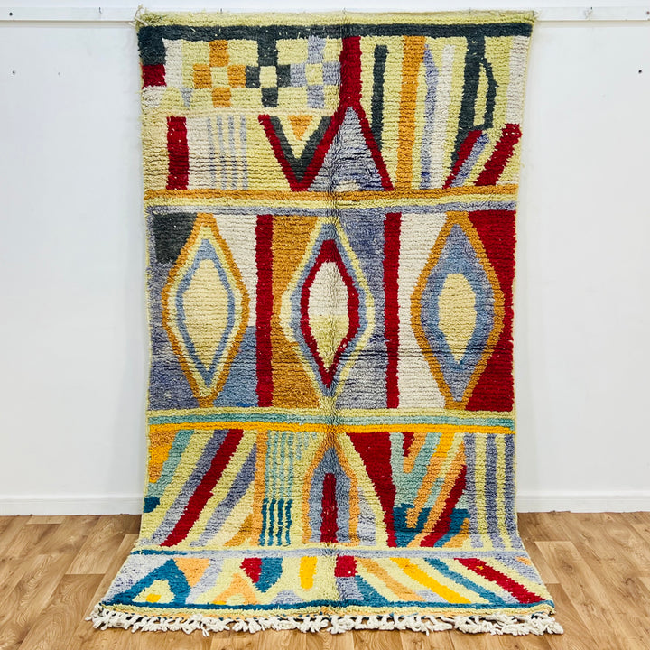 Colorful vintage Moroccan rug with vibrant geometric Berber patterns, handwoven from wool. Moroccan rug for sale.