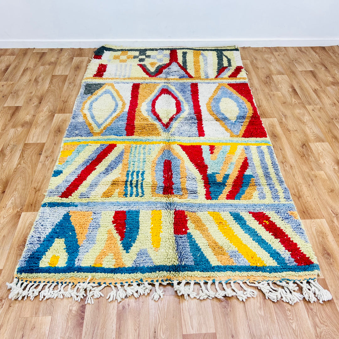 Rare colorful Moroccan rug with vintage Berber design, featuring vibrant geometric patterns in reds, blues, and creams.