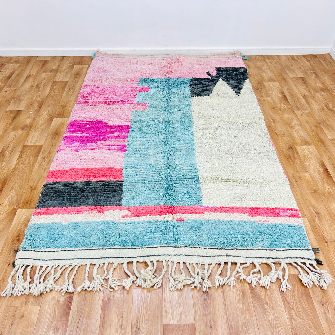 One-of-a-kind pink and blue Moroccan Berber rug, 8x5 ft, handcrafted with natural wool, showcasing abstract desert-inspired designs.