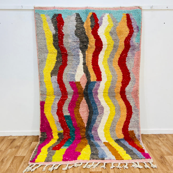 Vintage Moroccan rug with colorful wave pattern in red, pink, teal, mustard, black, and cream, 8.4x5.1 ft, traditional Berber design.