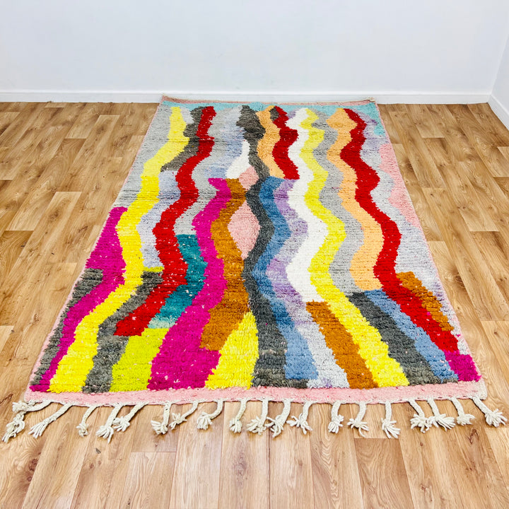Vintage Moroccan rug with colorful wave pattern, 8.4x5.1 ft, featuring bold red, pink, teal, mustard, and black tones; 100% wool.