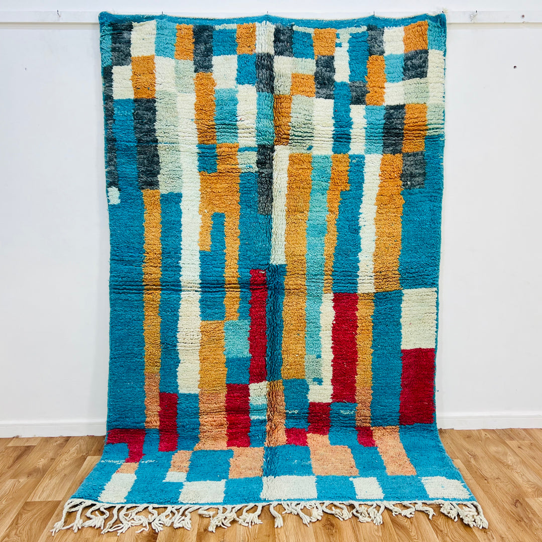Vintage Moroccan Berber rug with turquoise, ochre, red, and charcoal geometric design; handwoven wool, size 207x161 cm.