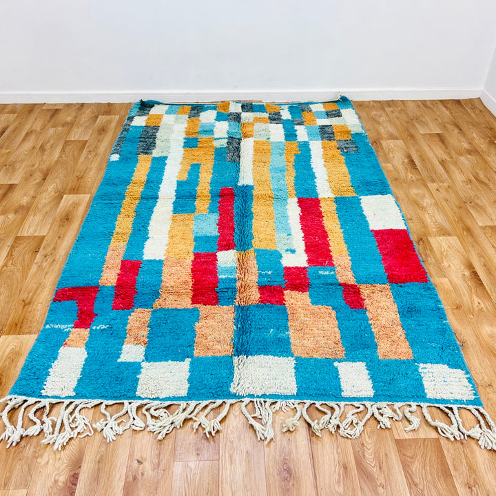 Vintage Moroccan rug with turquoise, ochre, red blocks. Handwoven Berber wool, geometric design. Moroccan rug for sale.