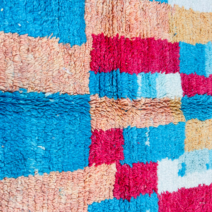 Vintage Moroccan Berber wool rug with vivid turquoise, ochre, cream, red, and charcoal blocks. Handwoven area rug from Morocco.