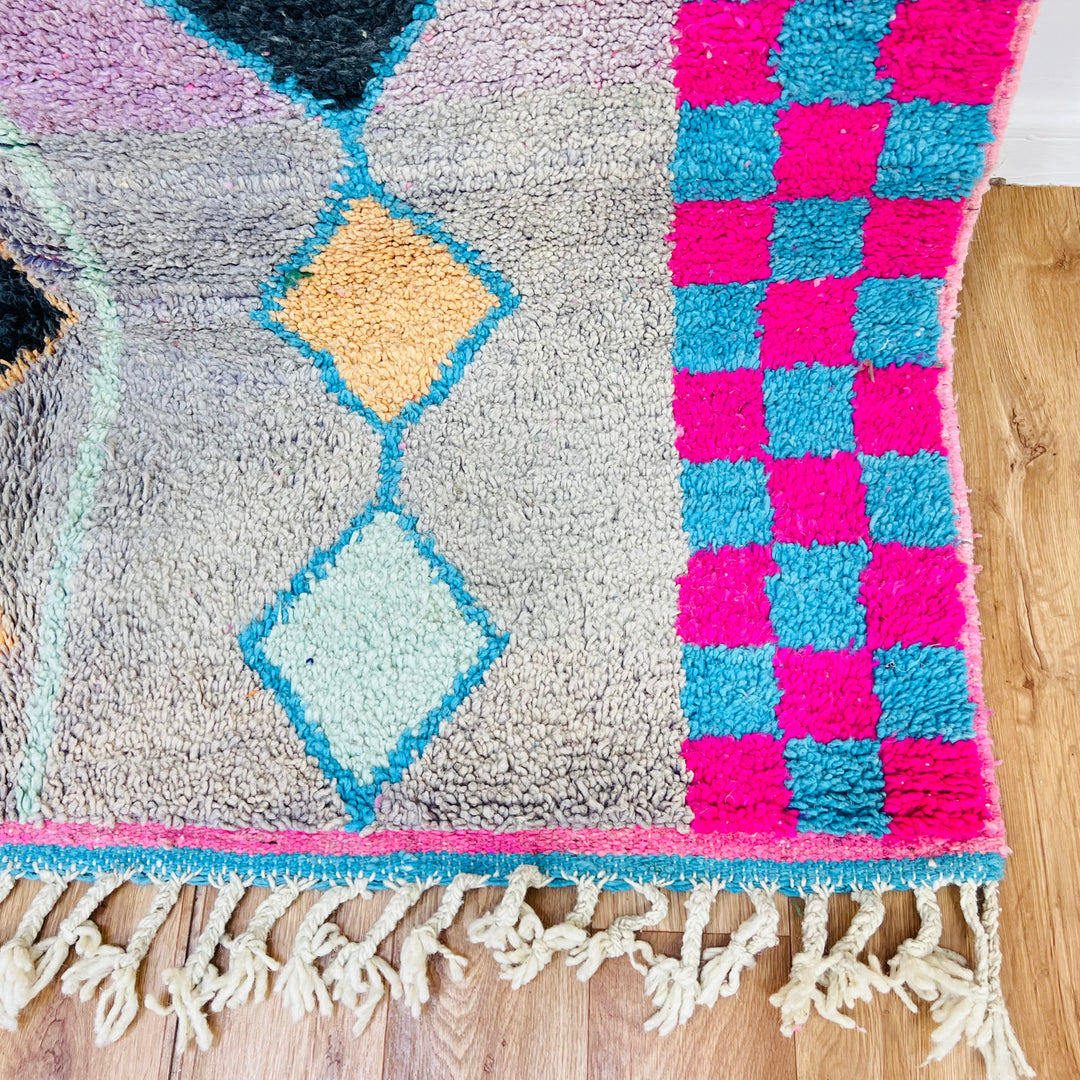 Handmade vintage Moroccan Berber rug with diamond patterns, pink and blue checkerboard, and fringe, perfect for modern decor.