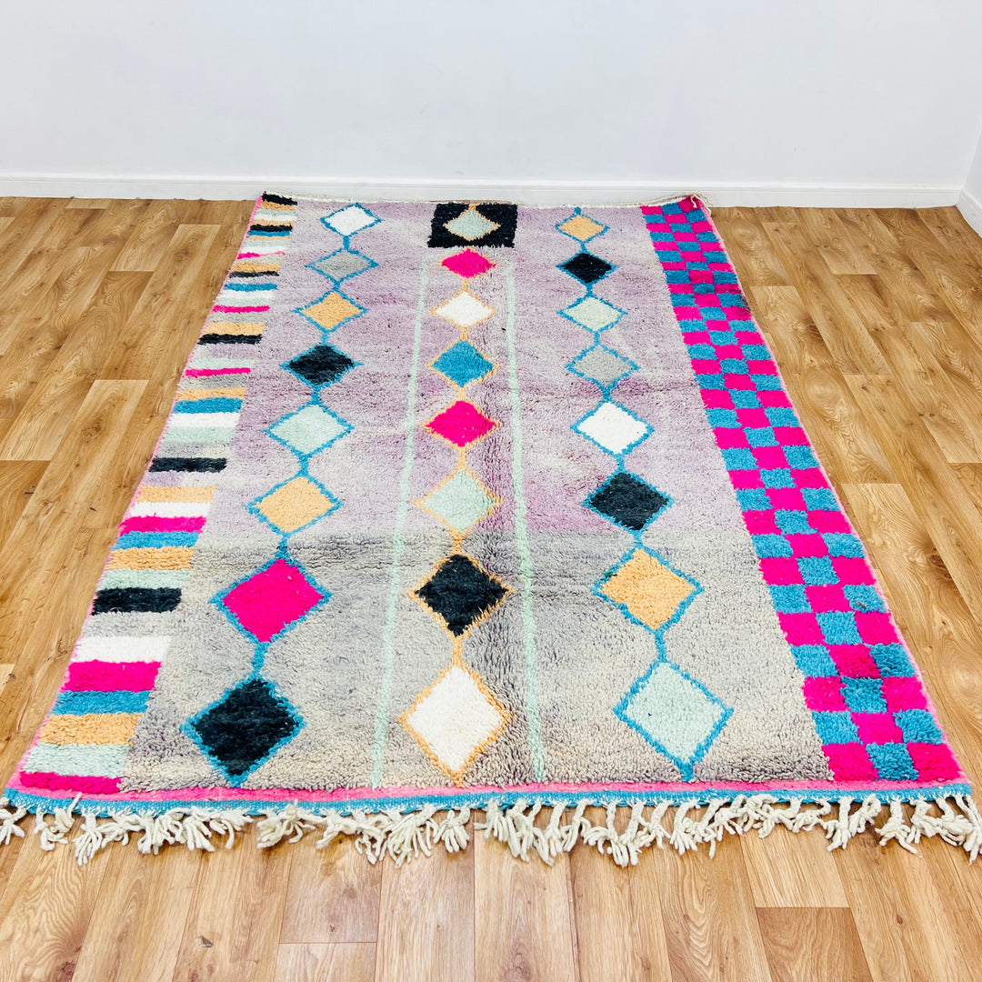 Vintage Moroccan rug with diamond motifs on lavender base, checkerboard pink and blue borders, handmade by Berber women. Rug 451.