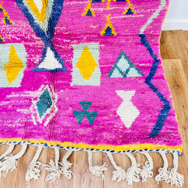 Pink Moroccan rug with tribal diamond and tree motifs, handwoven wool, 164x155 cm, vibrant colors by Berber artisans.
