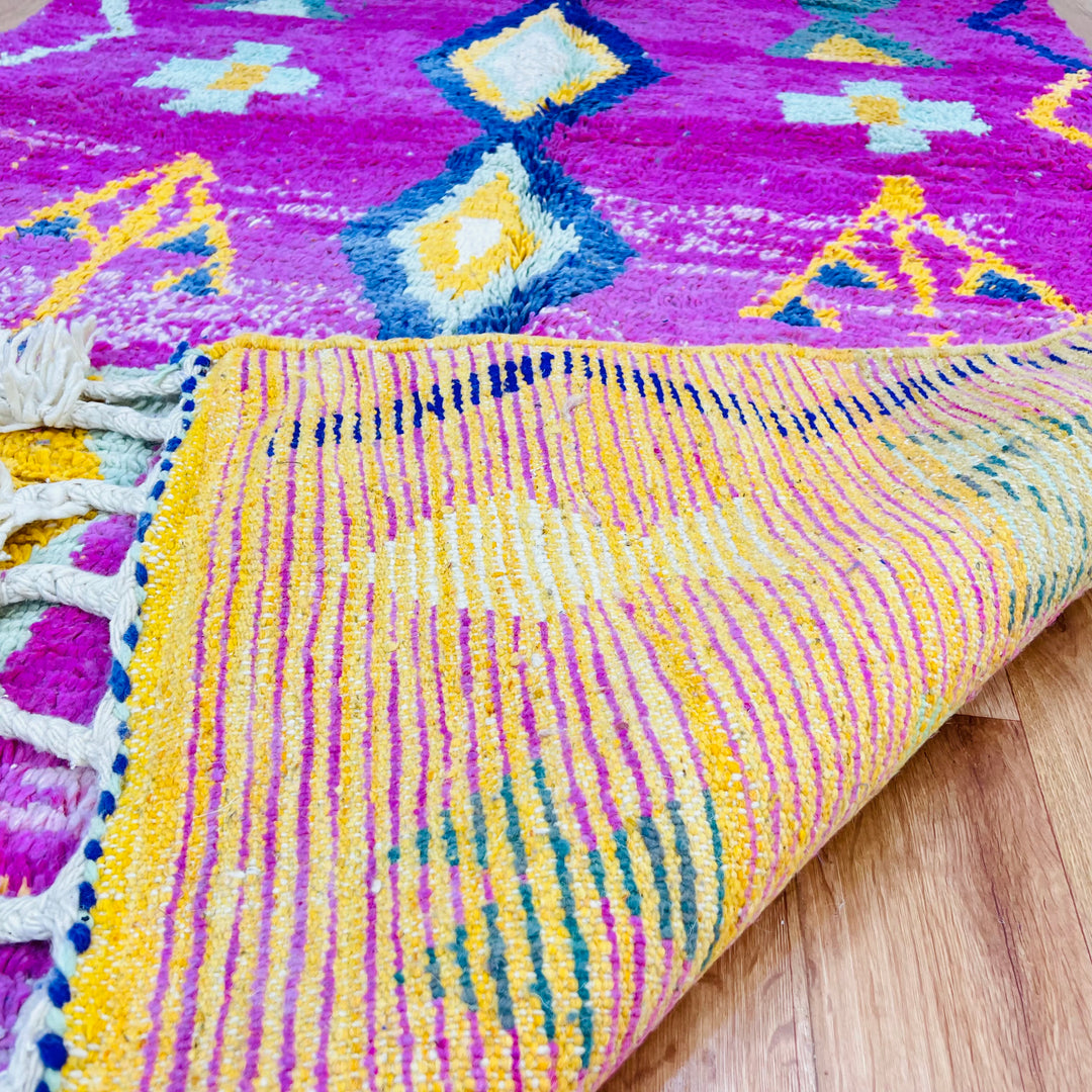 Pink Moroccan rug with tribal symbols, handwoven by Berber artisans, featuring vibrant diamond motifs. Size 164x155 cm.