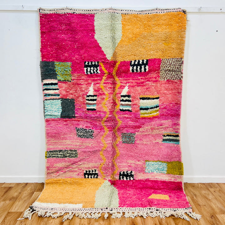 Pink abstract Moroccan rug with colorful accents, handwoven by Berber artisans, 245 x 162 cm, wool texture, unique design.