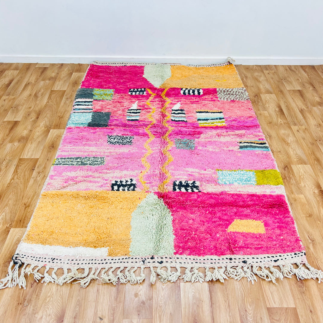 Pink abstract Moroccan rug with vivid colors and wool texture, 245 x 162 cm. Handwoven Berber design, perfect for modern interiors.