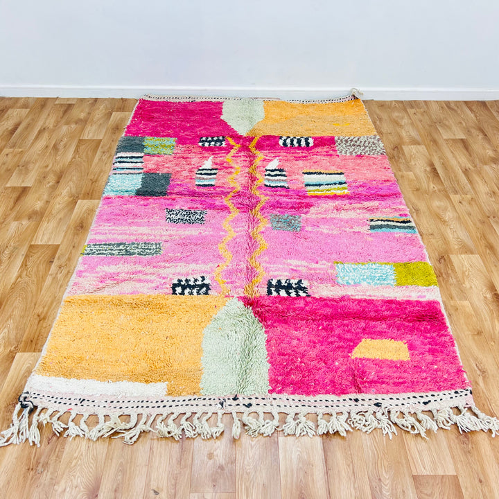 Pink abstract Moroccan rug with vivid colors and wool texture, 245 x 162 cm. Handwoven Berber design, perfect for modern interiors.