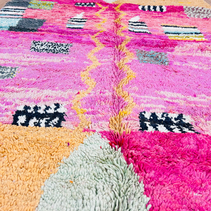 Pink abstract Moroccan rug with pink, yellow, and mint tones, handwoven in wool by Berber artisans. Size: 245 x 162 cm.