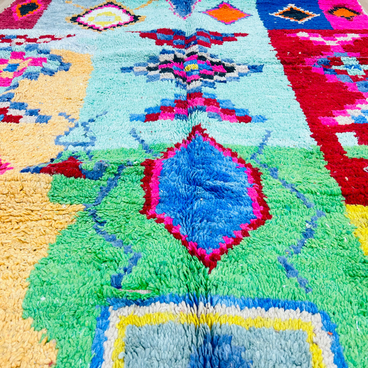 Colorful vintage Moroccan Berber rug with geometric patterns in pink, turquoise, orange, red, and blue, handcrafted wool.
