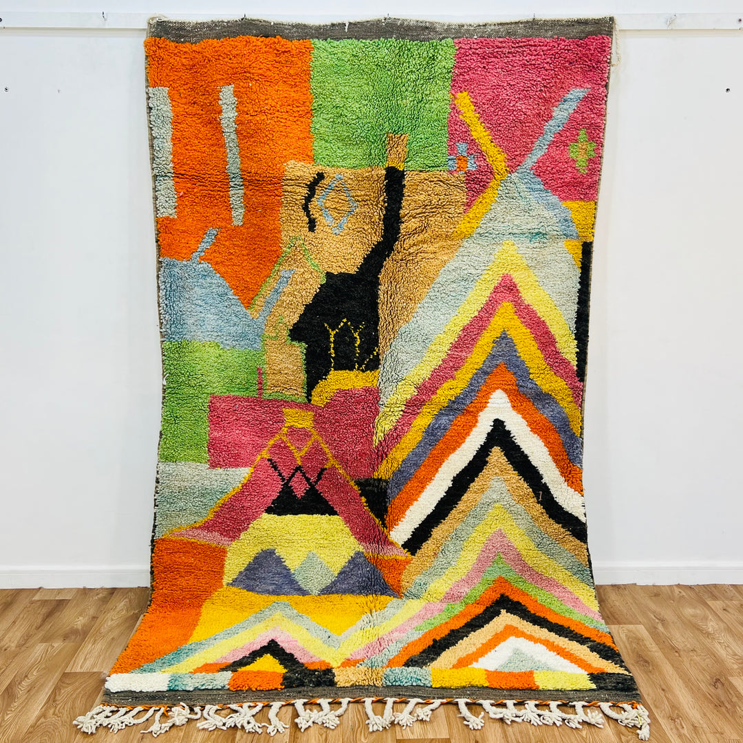 Colorful Chevron Moroccan Rug showcasing vibrant zigzag patterns, handwoven by Berber women; a bold addition to any space.