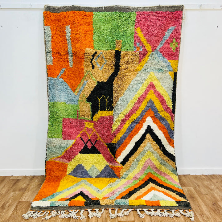 Colorful Chevron Moroccan Rug showcasing vibrant zigzag patterns, handwoven by Berber women; a bold addition to any space.